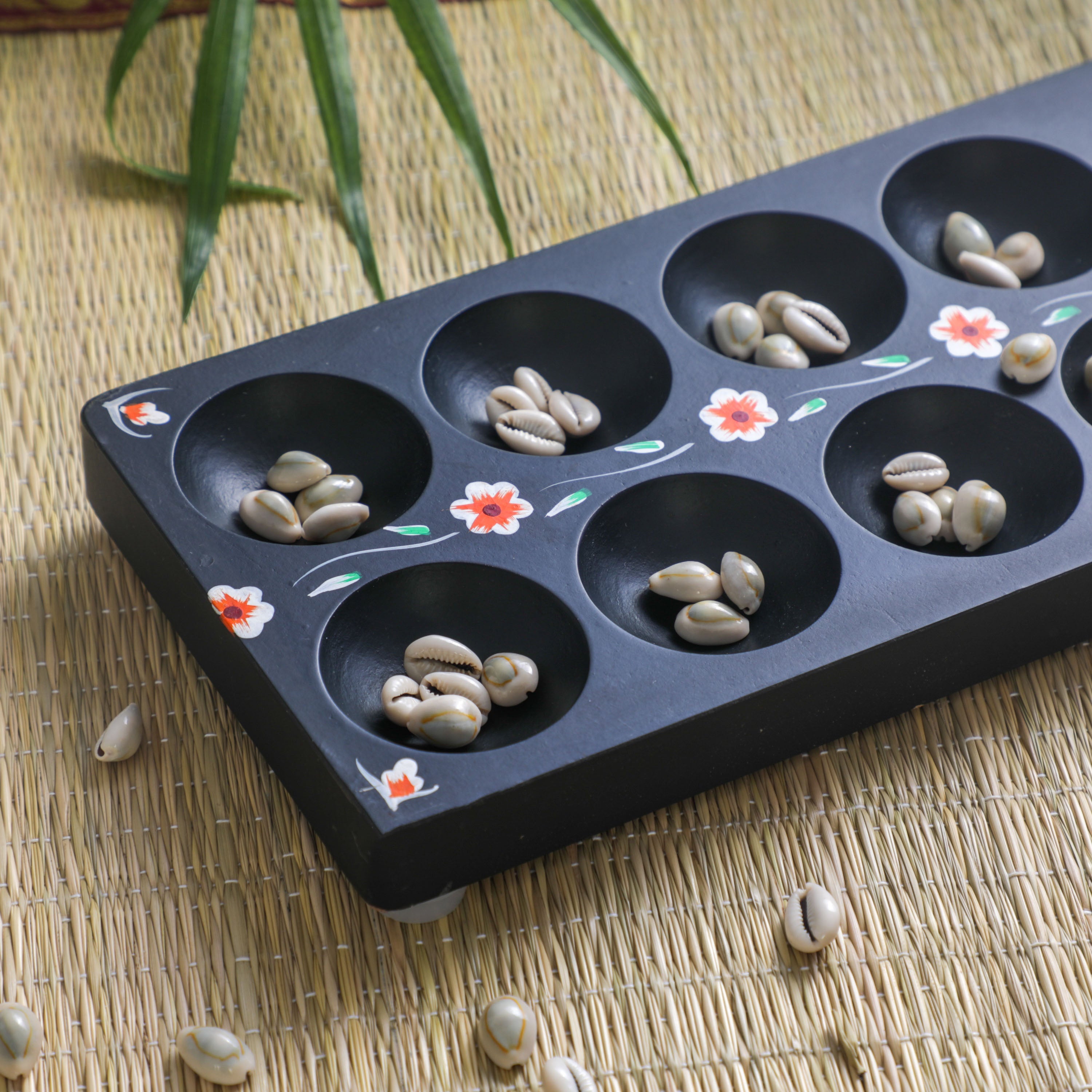 sea shells in a carved wooden indian game